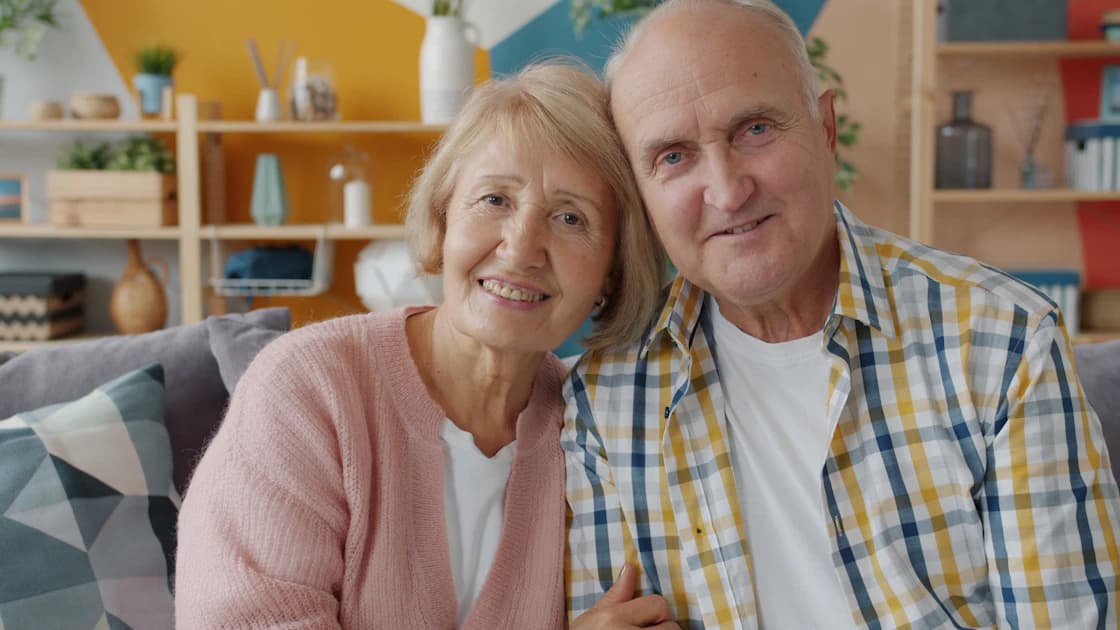 Elderly couple smiling together at home